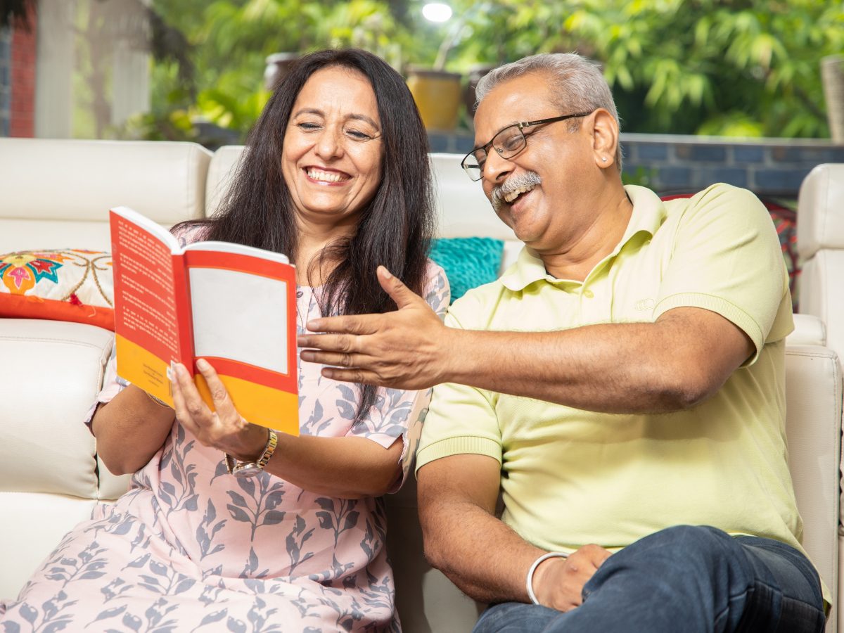 Happy,Senior,Indian,Couple,Reading,Book,Or,Novel,Together,At